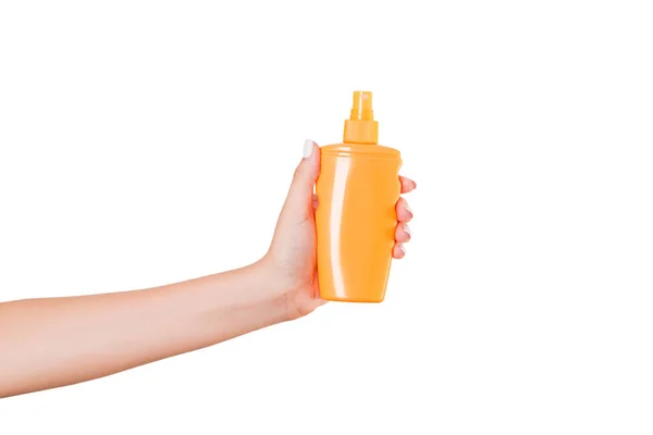 Female hand holding cream bottle of lotion isolated. Girl give cosmetic products on white background — Stock Photo, Image