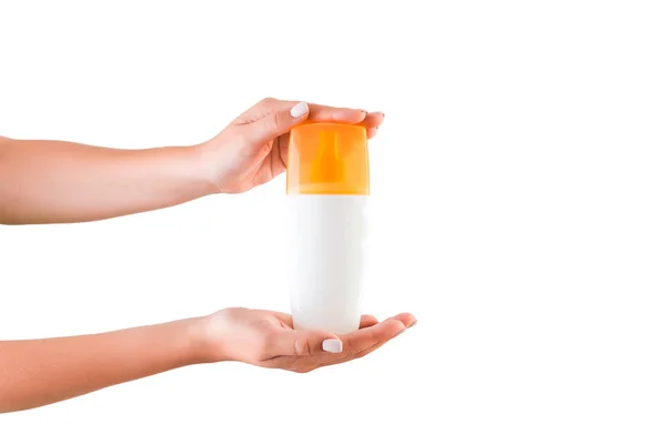 Botella de crema de mano femenina de loción aislada. Chica dar productos cosméticos sobre fondo blanco — Foto de Stock