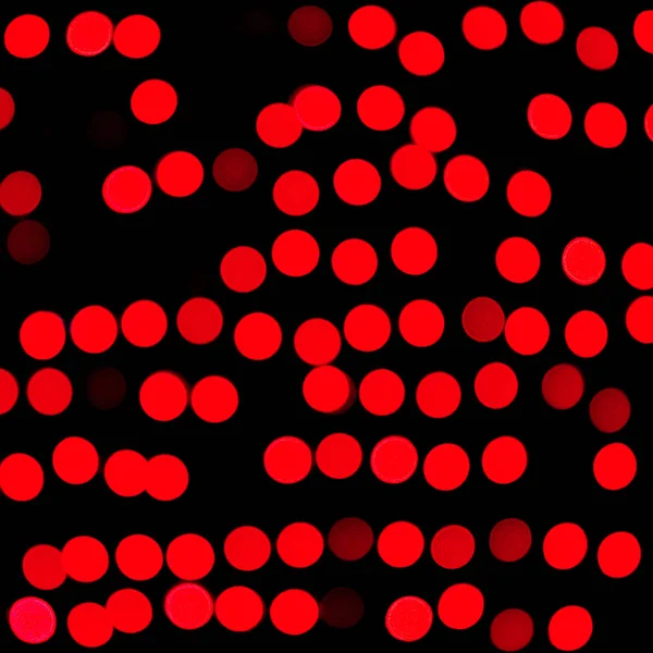 Bokeh abstracto rojo desenfocado sobre fondo negro. desenfocado y difuminado muchas luces redondas —  Fotos de Stock