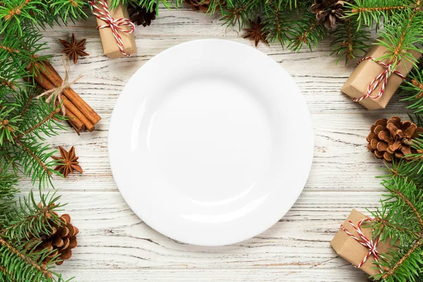 top view. Empty plate round ceramic on wooden christmas background. holiday dinner dish concept with new year decor