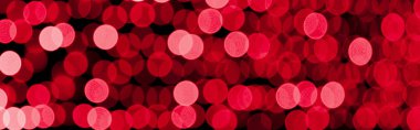 Siyah arka planda odaklı olmayan soyut kırmızı bokeh. defocused ve bulanık birçok yuvarlak ışık