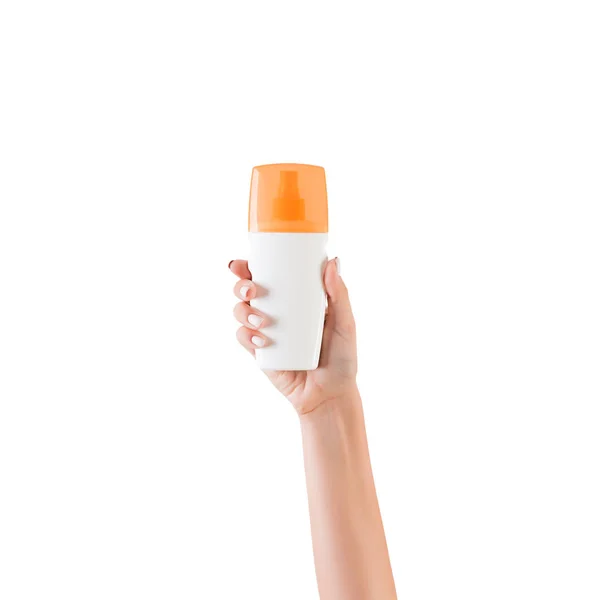 Mão feminina segurando creme garrafa de loção isolada. Menina dar produtos cosméticos no fundo branco — Fotografia de Stock