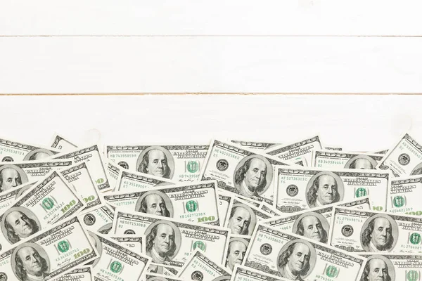 Top view banknotes on colored desk with copy space on top. one hundred dollar bills with stack of money in the middle. Top view of business concept — Stock Photo, Image