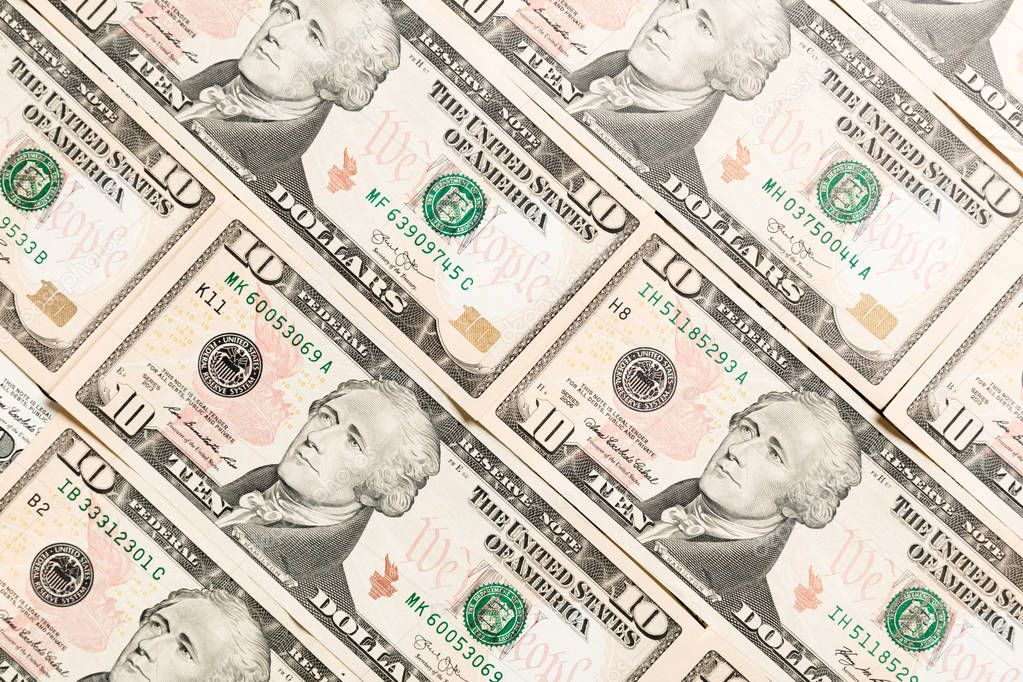 Close up of 10 dollar bills as a background. Amarican dollars pattern. Top view of business concept