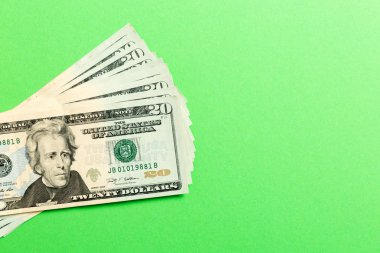 Renkli arka plan üzerinde 20 dolarlık banknotlar yığını. Tasarımınız için boş alan ile finansal kavramın en iyi görünümü