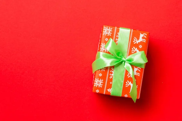 圣诞或新年礼物盒，背景为红色，顶部有复盖空间，有绿色蝴蝶结 — 图库照片