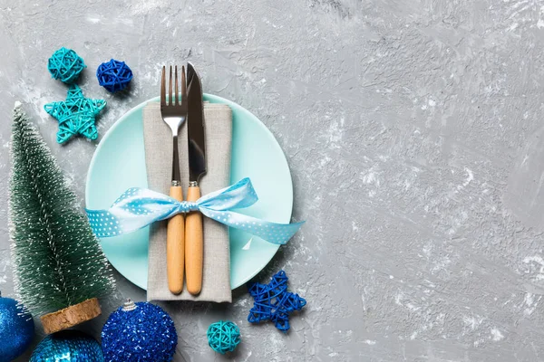 Holiday composition of Christmas dinner on cement background. Top view of plate, utensil and festive decorations. New Year Advent concept with copy space — Stock Photo, Image