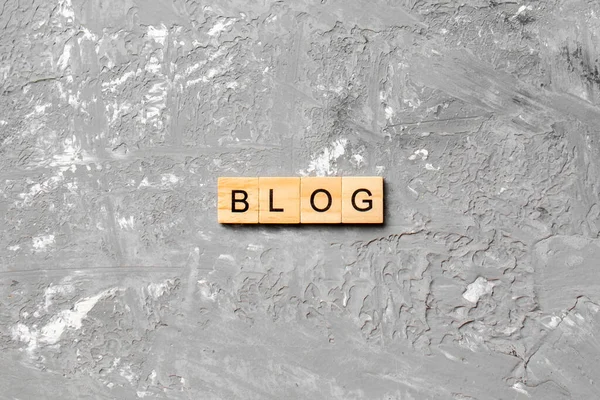 BLOG word written on wood block. BLOG text on cement table for your desing, concept.