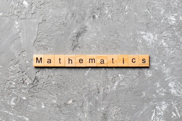 用木块写的数学字 水泥桌上的数学课本 供您设计 — 图库照片