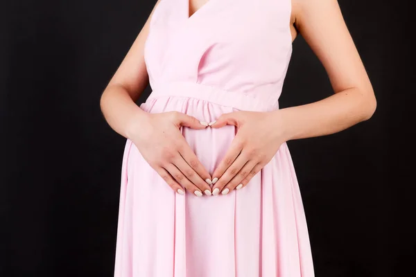 Zbliżenie Młodej Kobiety Ciąży Tworzącej Kształt Serca Rękami Brzuchu Czarnym — Zdjęcie stockowe