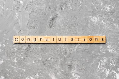 congratulations word written on wood block. congratulations text on cement table for your desing, concept. clipart