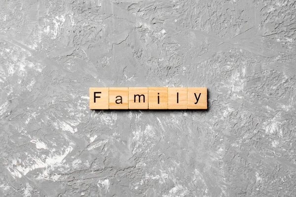 family word written on wood block. family text on table, concept.