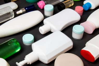 Plastik gövde bakımı şişesi düz kompozisyonu ve renkli arka plan boşluğuna kozmetik ürünler dizayn edilmişti. Beyaz Kozmetik kapları kümesi, kopya alanı ile üst görünüm.