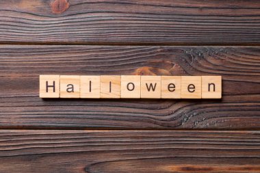 Ahşap blokta yazan cadılar bayramı kelimesi. Masada Cadılar Bayramı metni, konsept.