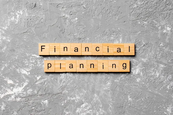 financial planning word written on wood block. financial planning text on cement table for your desing, concept.
