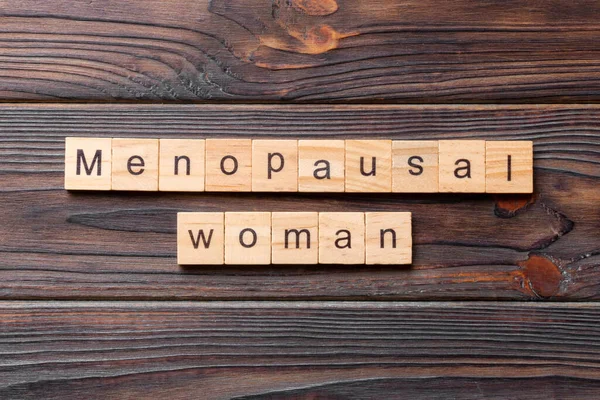 menopausal woman word written on wood block. menopausal woman text on cement table for your desing, concept.