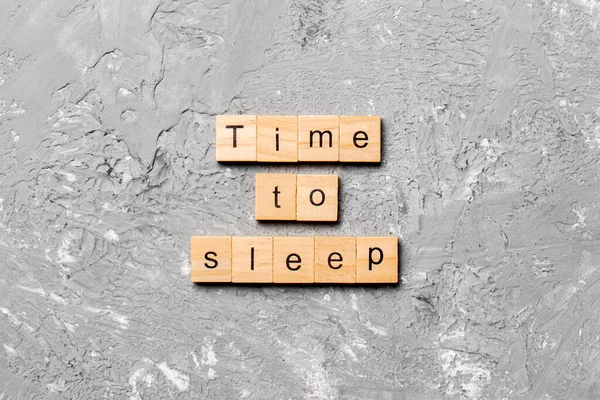 time to sleep word written on wood block. time to sleep text on cement table for your desing, concept.