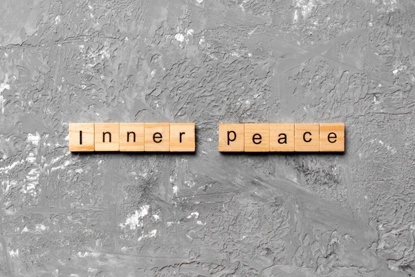 inner peace word written on wood block. inner peace text on table, concept.