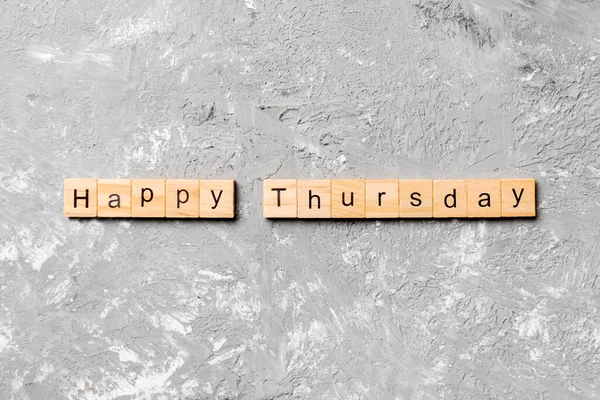 Happy thursday word written on wood block. Happy thursday text on cement table for your desing, concept.