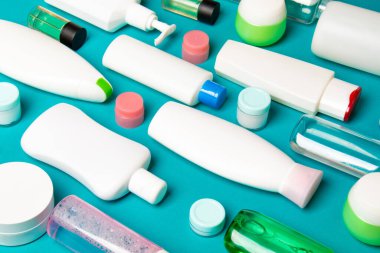 Plastik gövde bakımı şişesi düz kompozisyonu ve renkli arka plan boşluğuna kozmetik ürünler dizayn edilmişti. Beyaz Kozmetik kapları kümesi, kopya alanı ile üst görünüm.