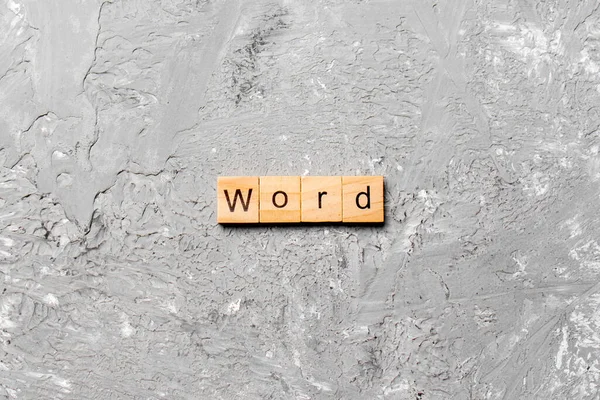 word written on wood block. WORD text on cement table for your desing, concept.