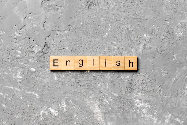 English Word Written Wood Block Английский Текст Цементном Столе Проектирования — стоковое фото