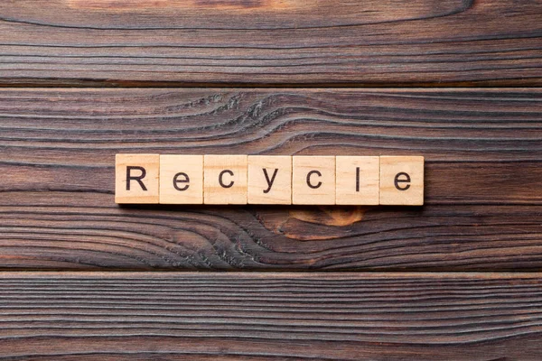 stock image recycle word written on wood block. recycle text on cement table for your desing, concept.