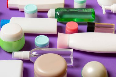 Farklı kozmetik şişeleri ve renkli arka planda kozmetik ürünleri için konteynır. Kopya alanı olan düz konum.