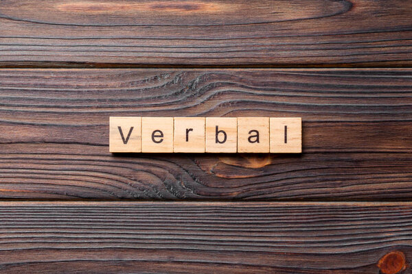 verbal word written on wood block. verbal text on table, concept.