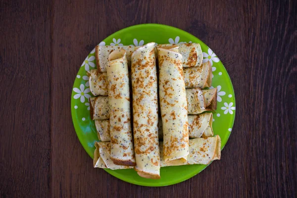 Pancakes rolls with cottage cheese. Pancakes with cheese on the plate. Maslenitsa.