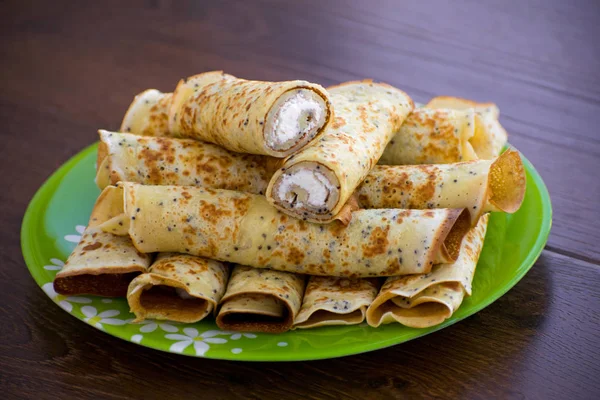 Pancakes rolls with cottage cheese. Pancakes with cheese. Maslenitsa.