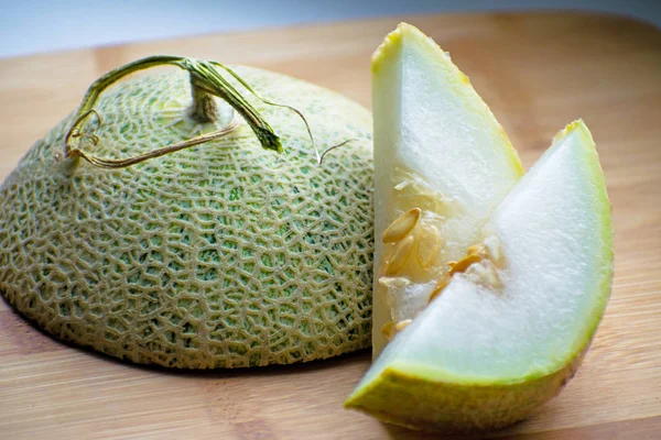 Fresh sweet green melon on the wooden board. Cantaloupe melon.