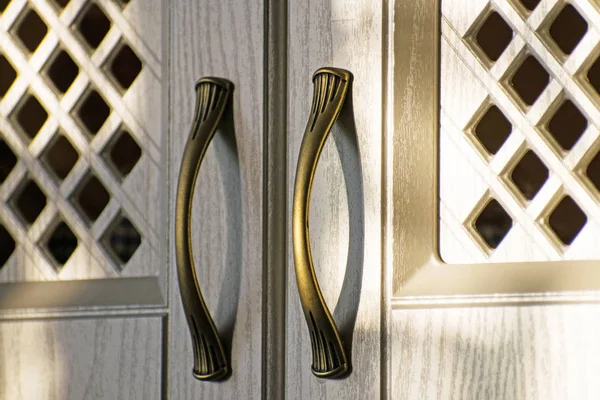 Retro handles metal cabinet in the kitchen.Close up of kitchen cabinet door knobs.