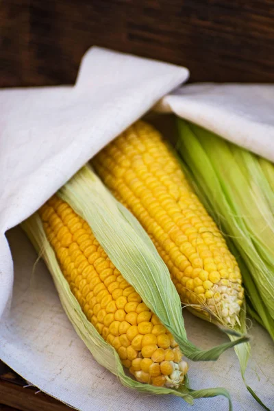 Fresh yellow corn on a wooden board. Row of delicious boiled fresh corn for a healthy snack.