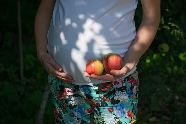 Pregnant woman with fresh apples.Pregnancy, food and happiness concept.Healthy pregnancy.