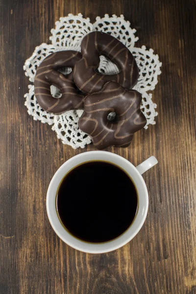 Cup of coffee and delicious gingerbreads. Christmas concept - festive gingerbreads with a cup of coffee.