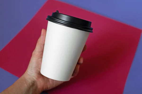 Mockup of female hand holding a coffee paper cup. — Stock Photo, Image