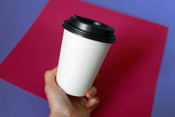 Mockup of female hand holding a coffee paper cup. — Stock Photo, Image