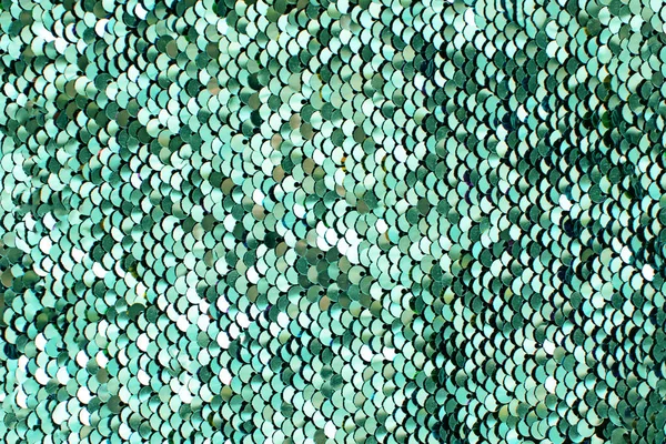 Tygstycken med neo Mint paljetter. Glitter bakgrund. Sequin konsistens. — Stockfoto