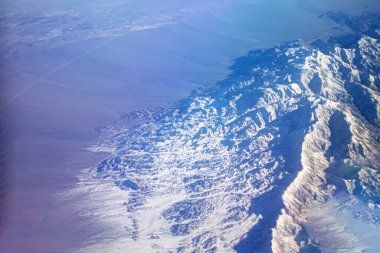 Uçak penceresinden güzel kış dağları.