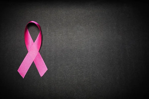 Pink ribbon for breast cancer awareness, symbolic bow color raising awareness on people living with women\'s breast tumor illness. bow isolated with clipping black background