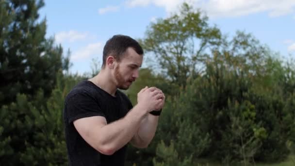 Muskelboxare med skäggträning slår med en imaginär motståndare utomhus. — Stockvideo