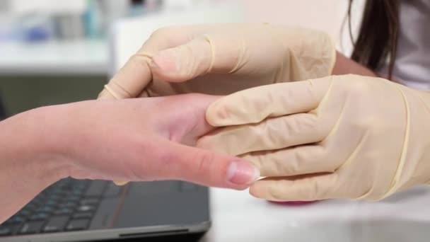 Visão de perto do podólogo feminino faz uma manicura terapêutica em uma clínica de beleza . — Vídeo de Stock