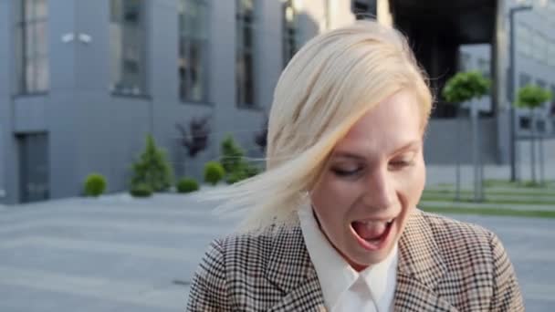 The blonde woman receives a positive message and rejoices in the success of the business. Successful closing of the project, positive emotions. — Stock Video