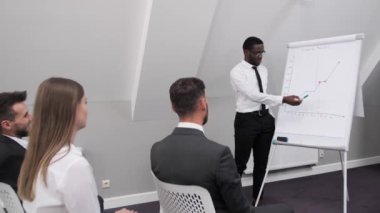 Afro-Amerikalı iş adamı konferans odasında bir rapor hazırlıyor ve şirketin kârını analiz ediyor. Takım çalışması kavramı..