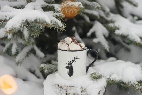 Ağacın altında kışın marshmallow ile iç.