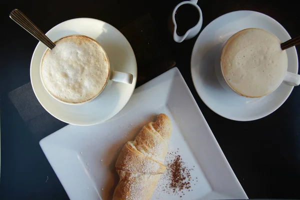 cappuccino and croissant in cafe