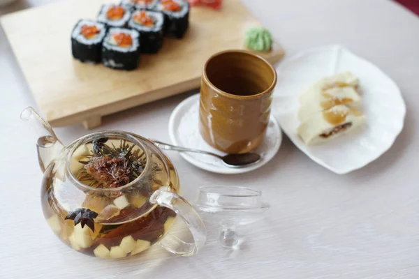 テーブルの上にお茶を入れたお寿司ロール付き日本料理 — ストック写真