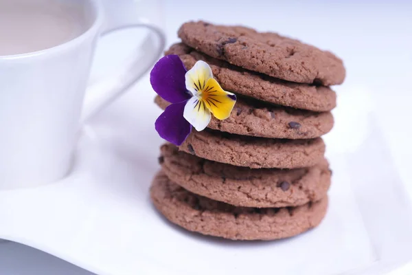 Stapel Schokoladenkekse Mit Blumen Und Tasse Kaffee Mit Milch — Stockfoto