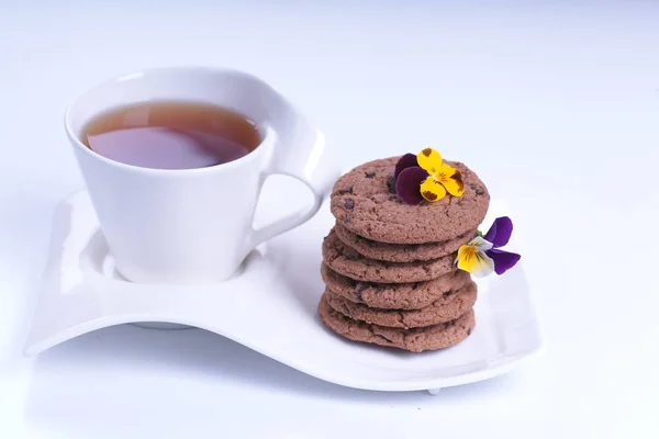 Cup Tea Stack Chocolate Cookies Flowers — Stock Photo, Image